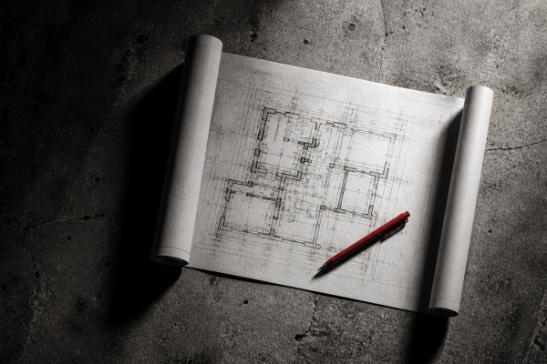 Planta estratégica sobre concreto representando o processo de desenvolvimento de estratégia de marca — Rebellum Studio